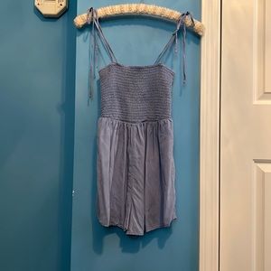 A romper with a smocked top half and adjustable tie straps for the perfect fit.